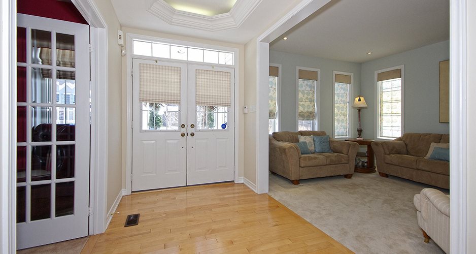 Hallway with maple floors and tray ceiling